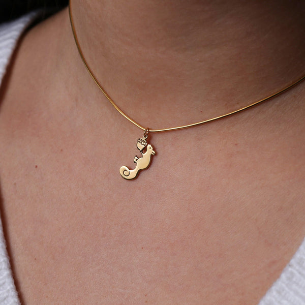Gold squirrel charm with a small acorn on a fine cable chain necklace