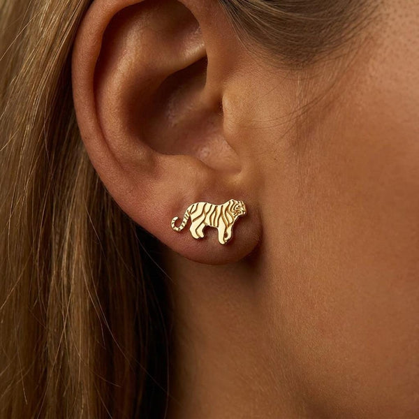 Small gold tiger stud earrings with cut stripe detail, shown as a pair