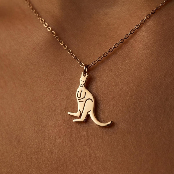 Small gold kangaroo pendant mid hop with outstretched tail on a fine chain