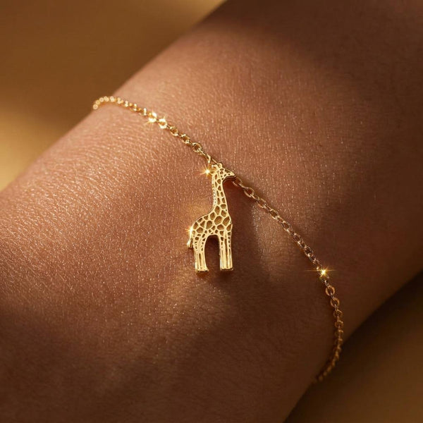 Small giraffe charm on a fine gold cable chain bracelet with clasp
