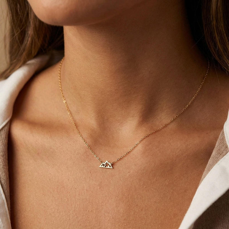 Tiny gold mountain peak pendant on a fine cable chain, shown flat on a white background (10 of 11)