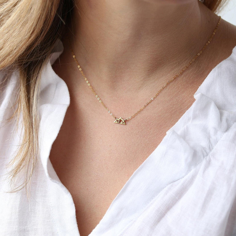 Tiny gold mountain peak pendant on a fine cable chain, shown flat on a white background (11 of 11)