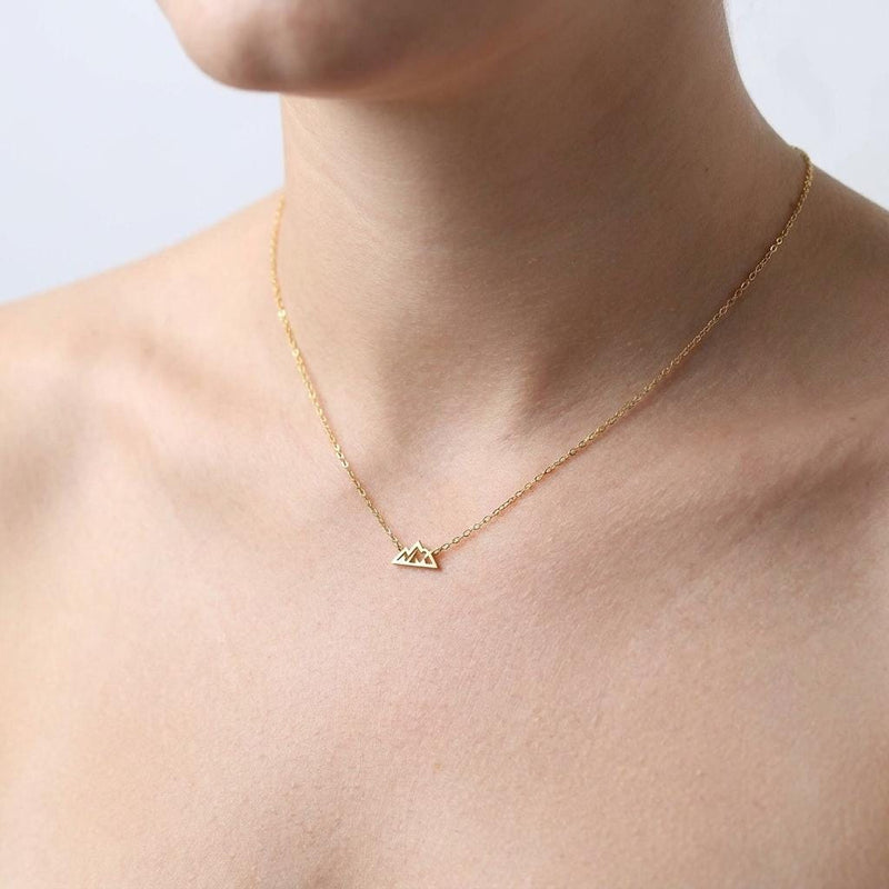 Tiny gold mountain peak pendant on a fine cable chain, shown flat on a white background (3 of 11)
