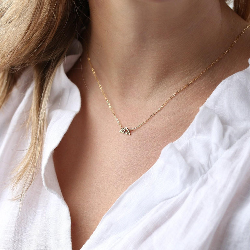 Tiny gold mountain peak pendant on a fine cable chain, shown flat on a white background (4 of 11)