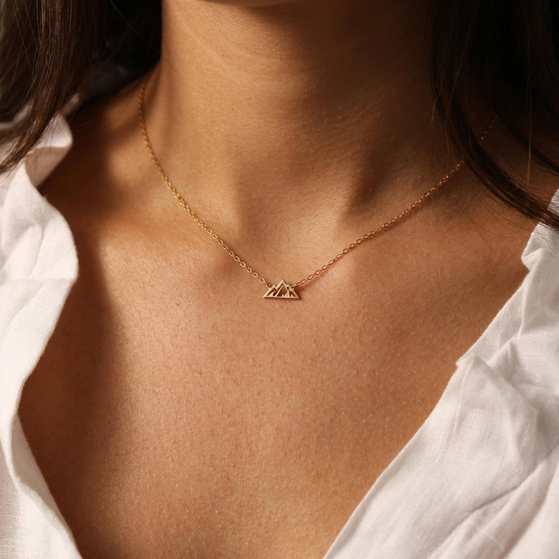 Tiny gold mountain peak pendant on a fine cable chain, shown flat on a white background (9 of 11)