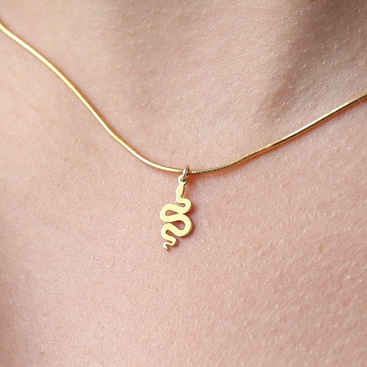 Small gold snake pendant curved into an S shape on a dainty cable chain choker (2 of 8)
