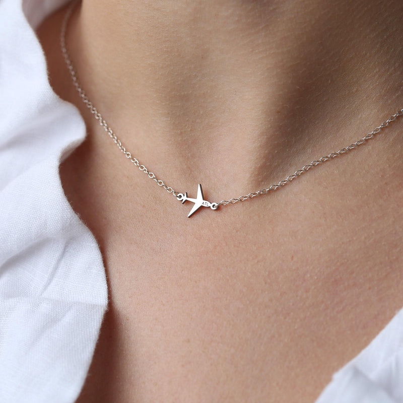 Small gold airplane pendant seen from above on a fine cable chain (3 of 9)