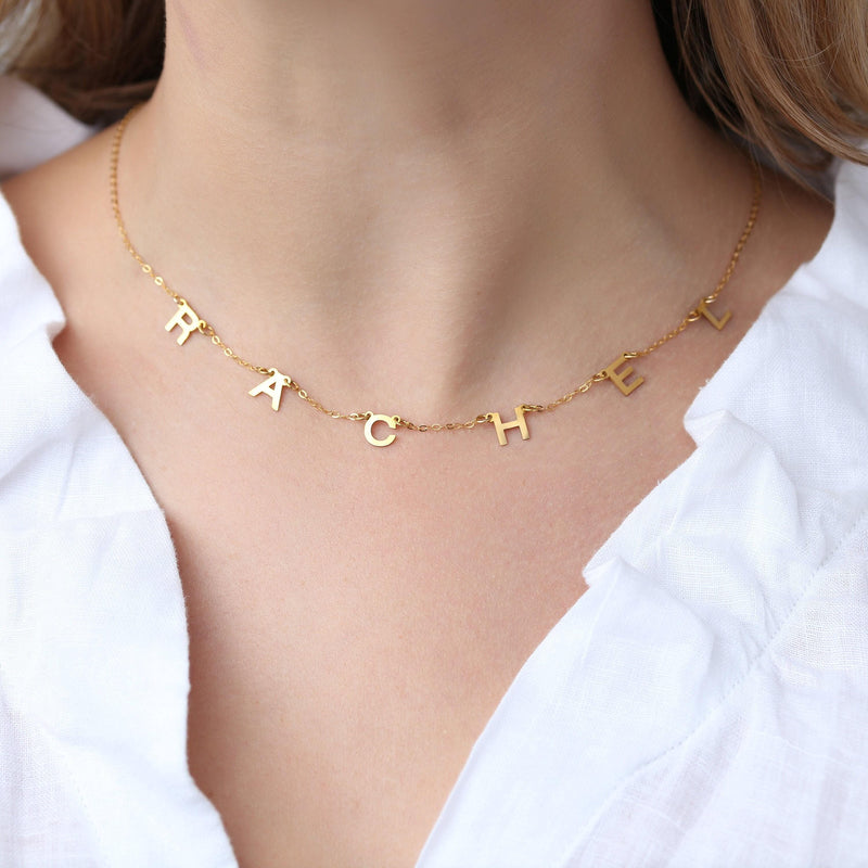 Small gold letter pendant on a fine cable chain, shown on a white background