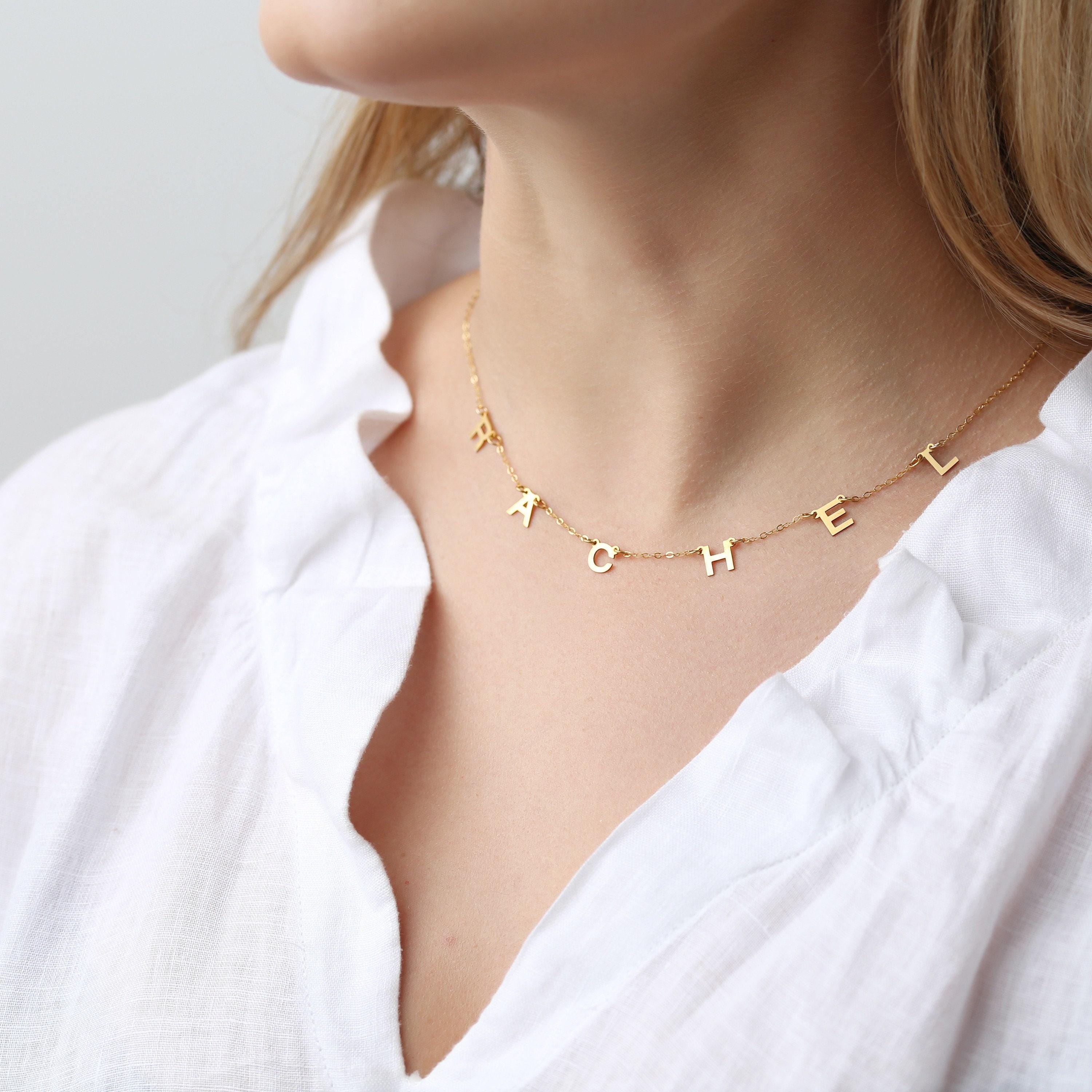 Small gold letter pendant on a fine cable chain, shown on a white background (2 of 8)