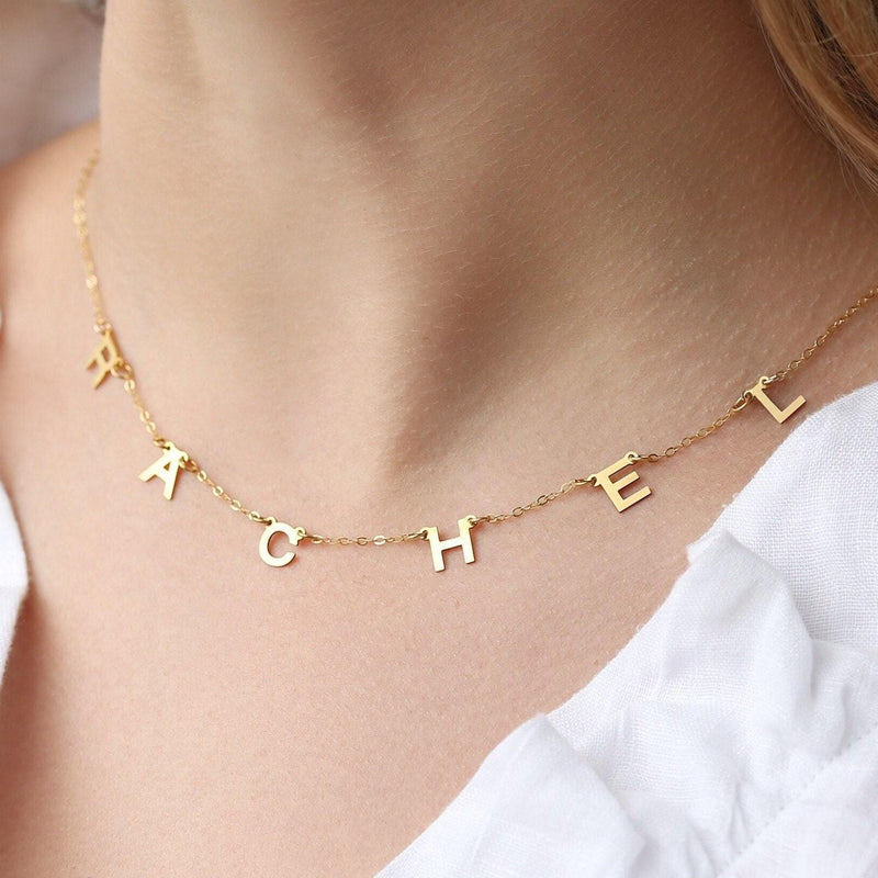 Small gold letter pendant on a fine cable chain, shown on a white background (3 of 8)