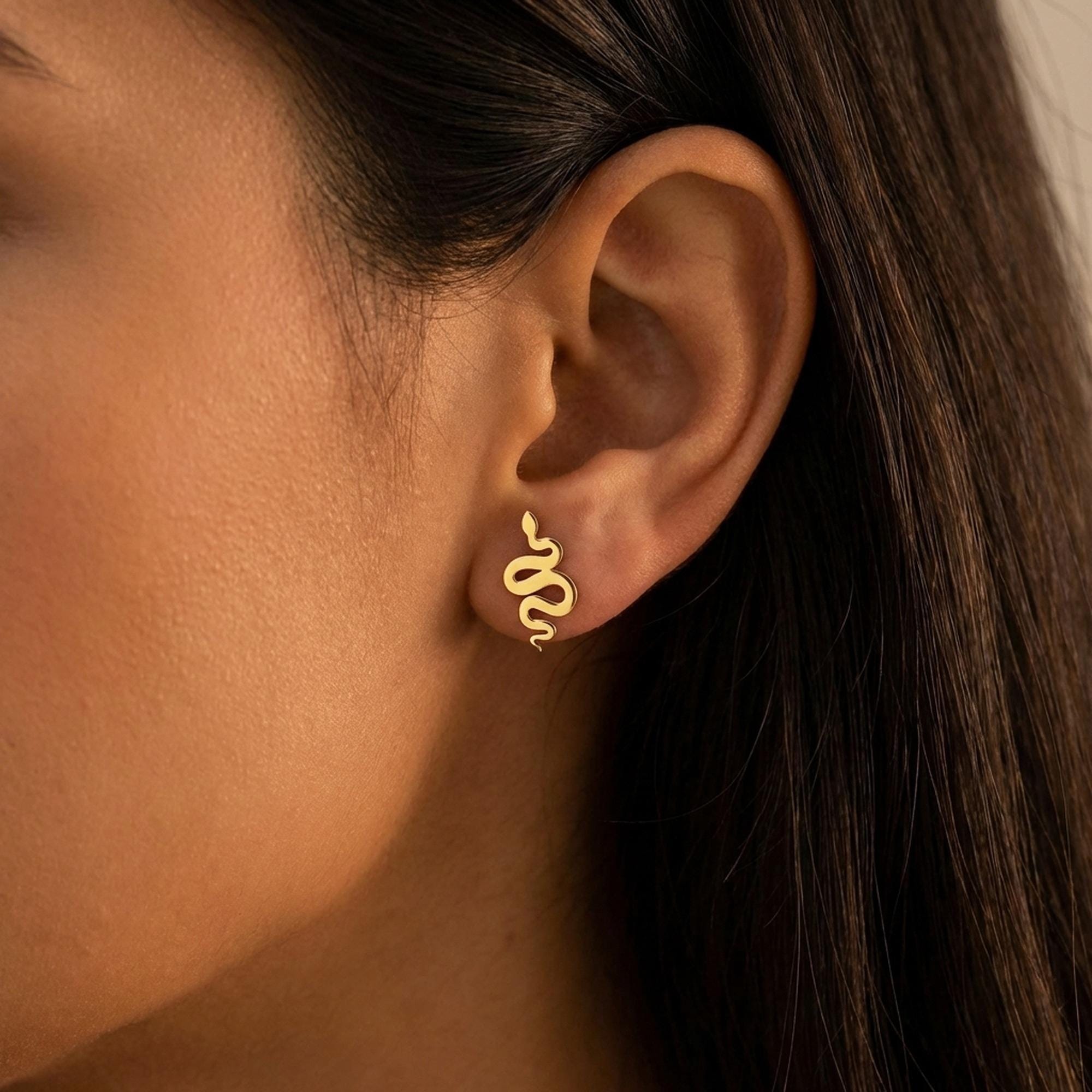 Pair of gold snake stud earrings curved into S shapes with tapered tails (2 of 9)