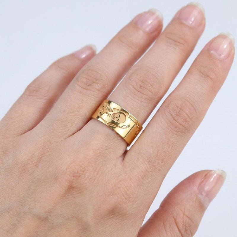 Thin gold ring with a flat skeleton figure along the band (2 of 9)