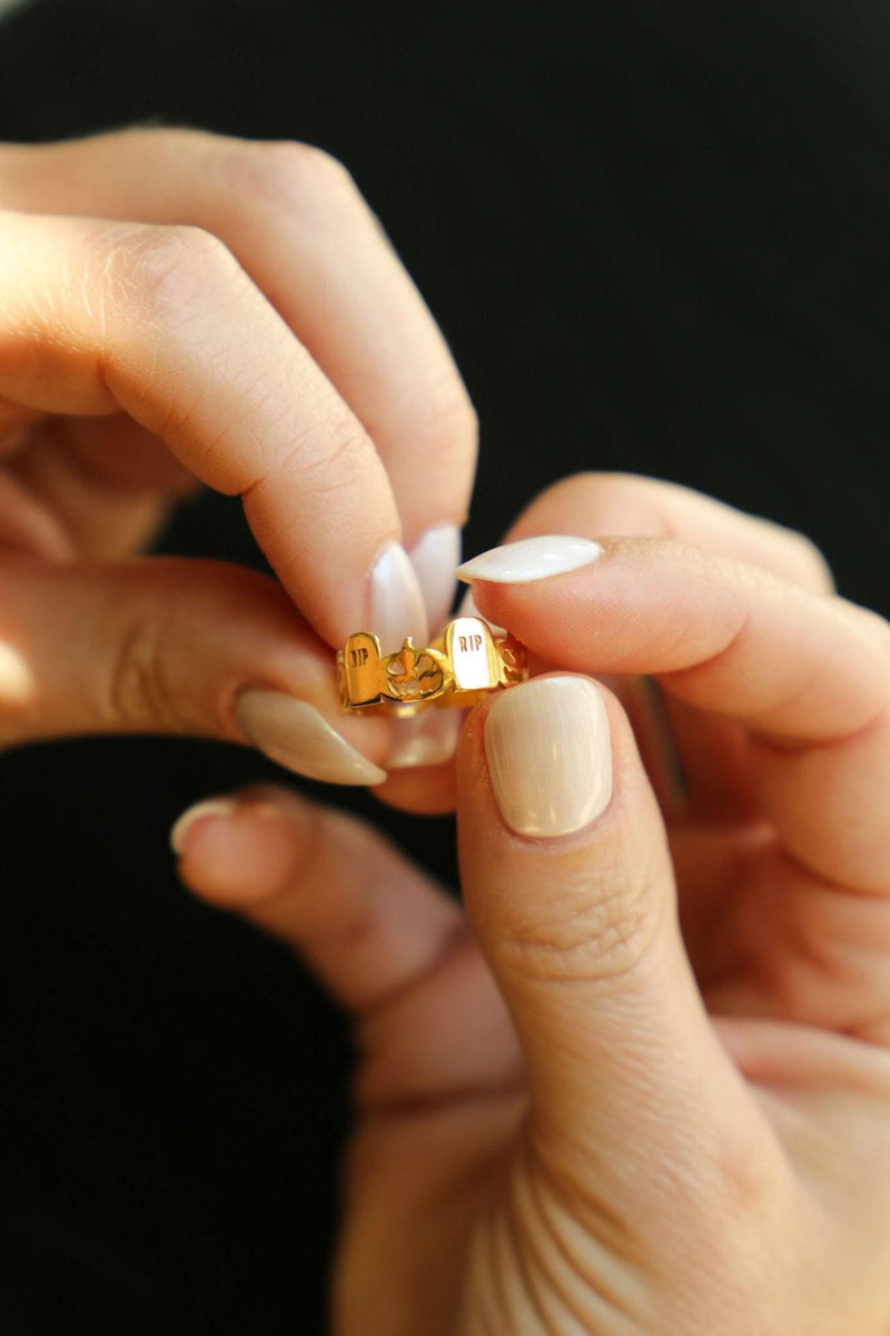 Thin gold stacking ring with a small RIP tombstone charm on the crown (2 of 15)