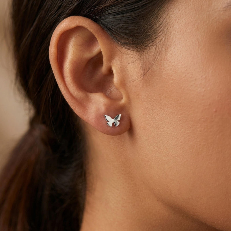 Two small gold butterfly stud earrings with open wings, front view. (10 of 10)