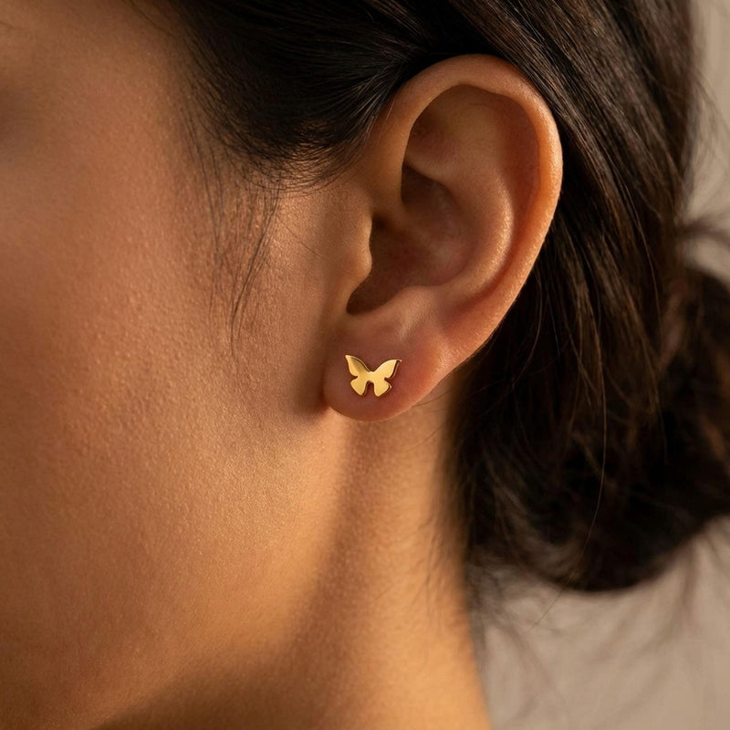Two small gold butterfly stud earrings with open wings, front view. (7 of 10)