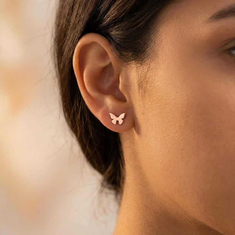 Two small gold butterfly stud earrings with open wings, front view. (8 of 10)