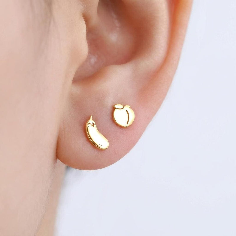 Mismatched pair of tiny gold peach and eggplant emoji stud earrings
