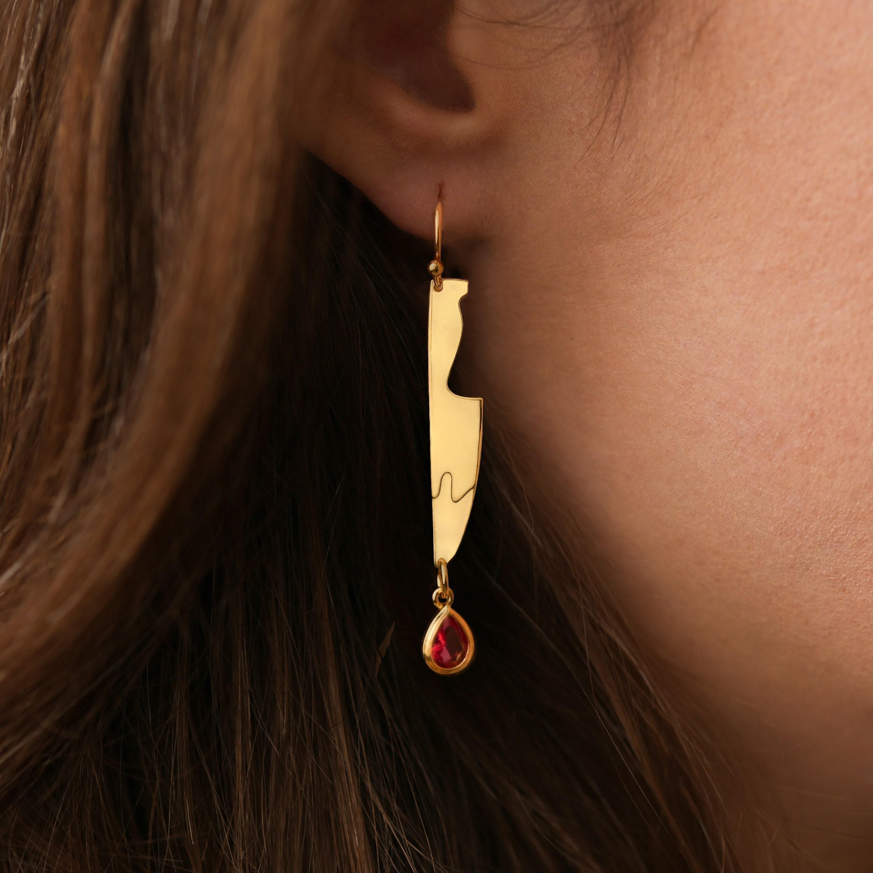 Long gold cleaver earrings with a red drop hanging from the blade edge (2 of 6)