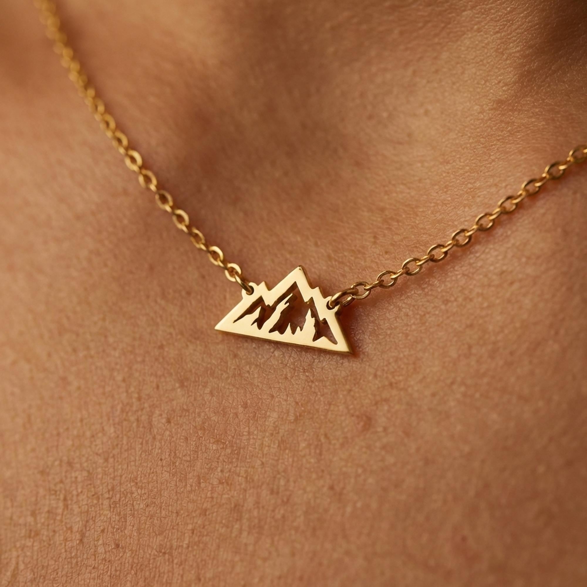 Small mountain range pendant hanging from a thin gold chain (2 of 9)