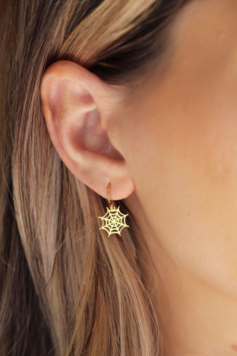 Pair of gold spider web dangle earrings with open line work