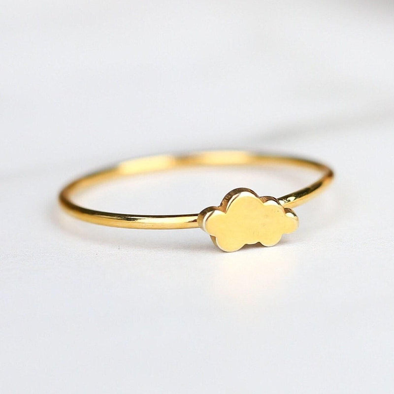 Dainty gold ring with a small cloud shape sitting on a thin round band
