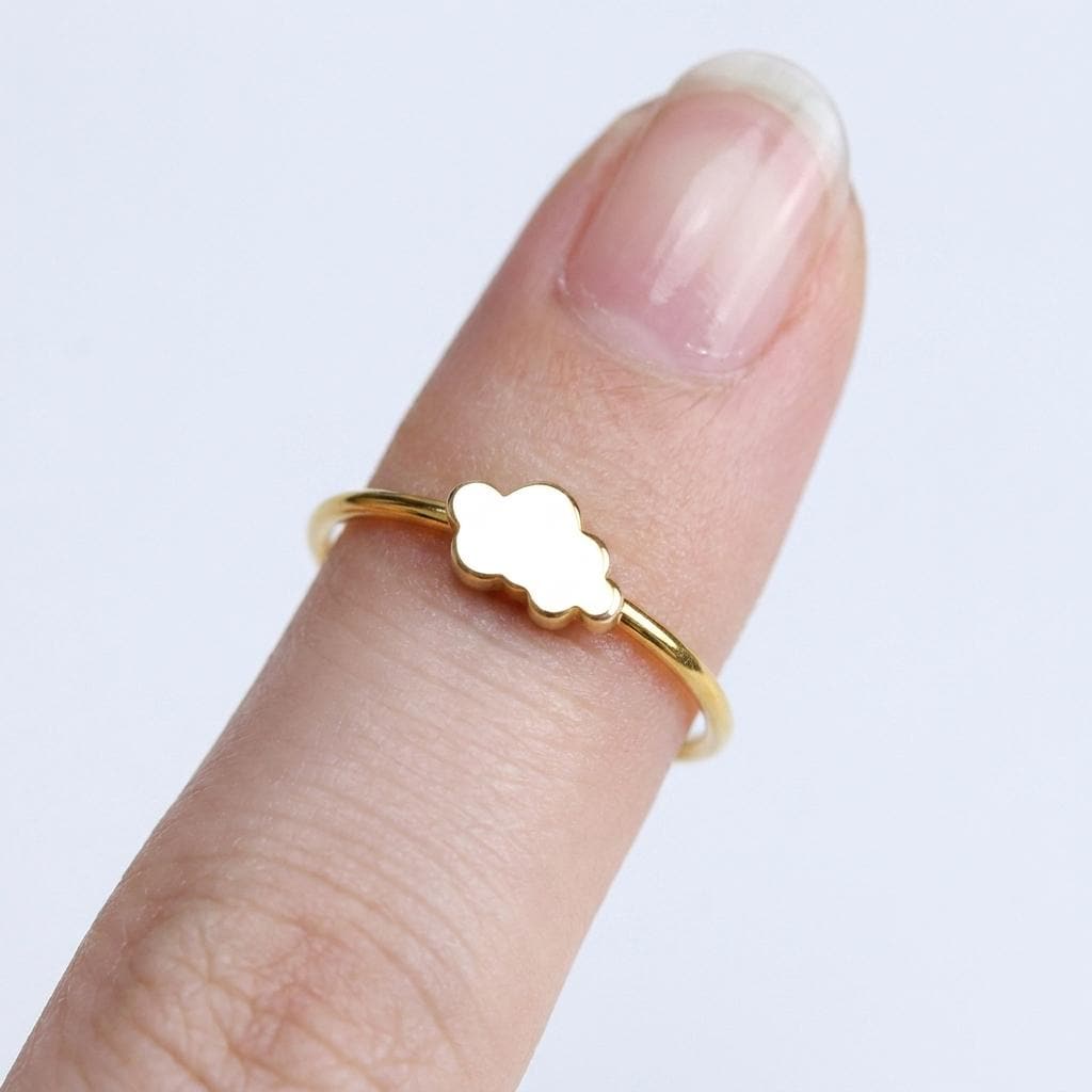 Dainty gold ring with a small cloud shape sitting on a thin round band (2 of 14)