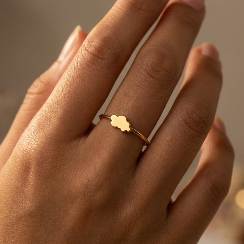 Dainty gold ring with a small cloud shape sitting on a thin round band (3 of 14)