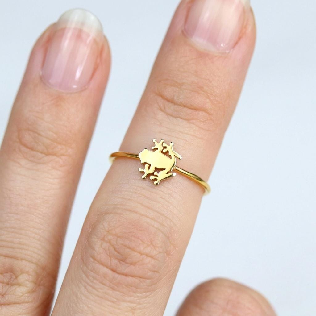 Dainty gold ring with a small crouching frog sitting on a very thin band (2 of 12)
