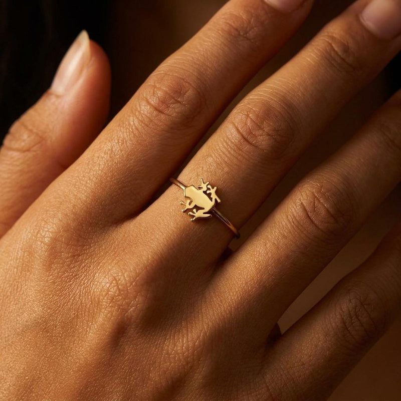 Dainty gold ring with a small crouching frog sitting on a very thin band (5 of 12)