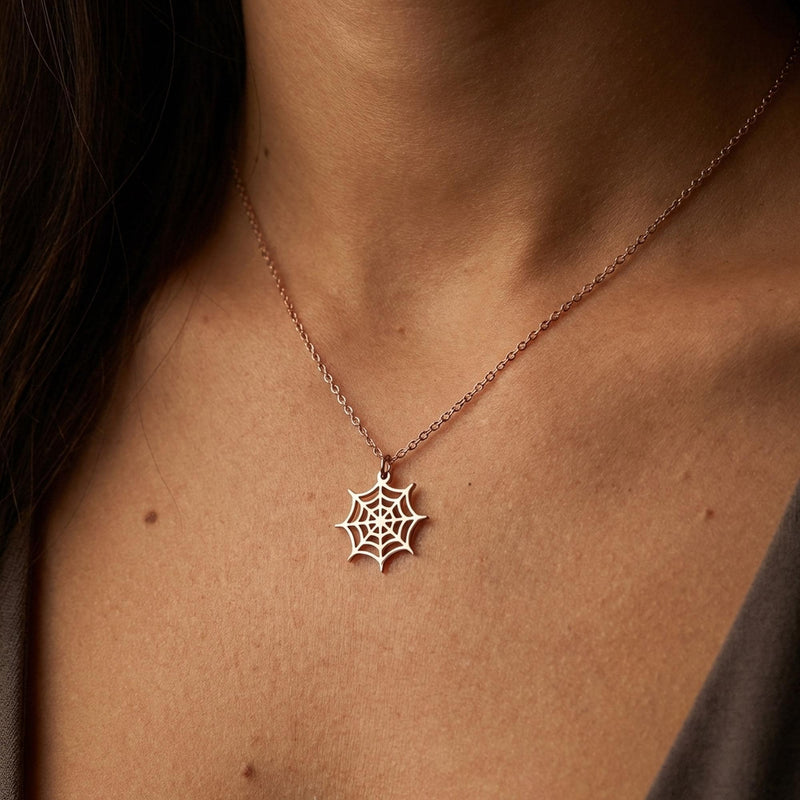 Dainty gold spider web pendant with fine radial threads, hanging from a thin gold-filled cable chain (13 of 13)