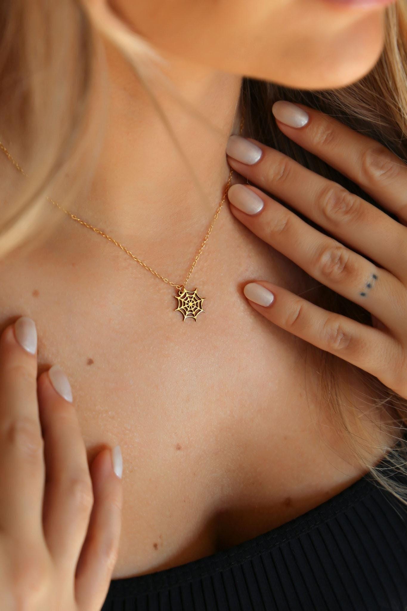Dainty gold spider web pendant with fine radial threads, hanging from a thin gold-filled cable chain (2 of 13)