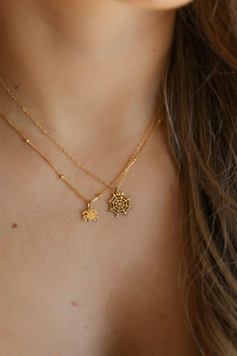Dainty gold spider web pendant with fine radial threads, hanging from a thin gold-filled cable chain (8 of 13)