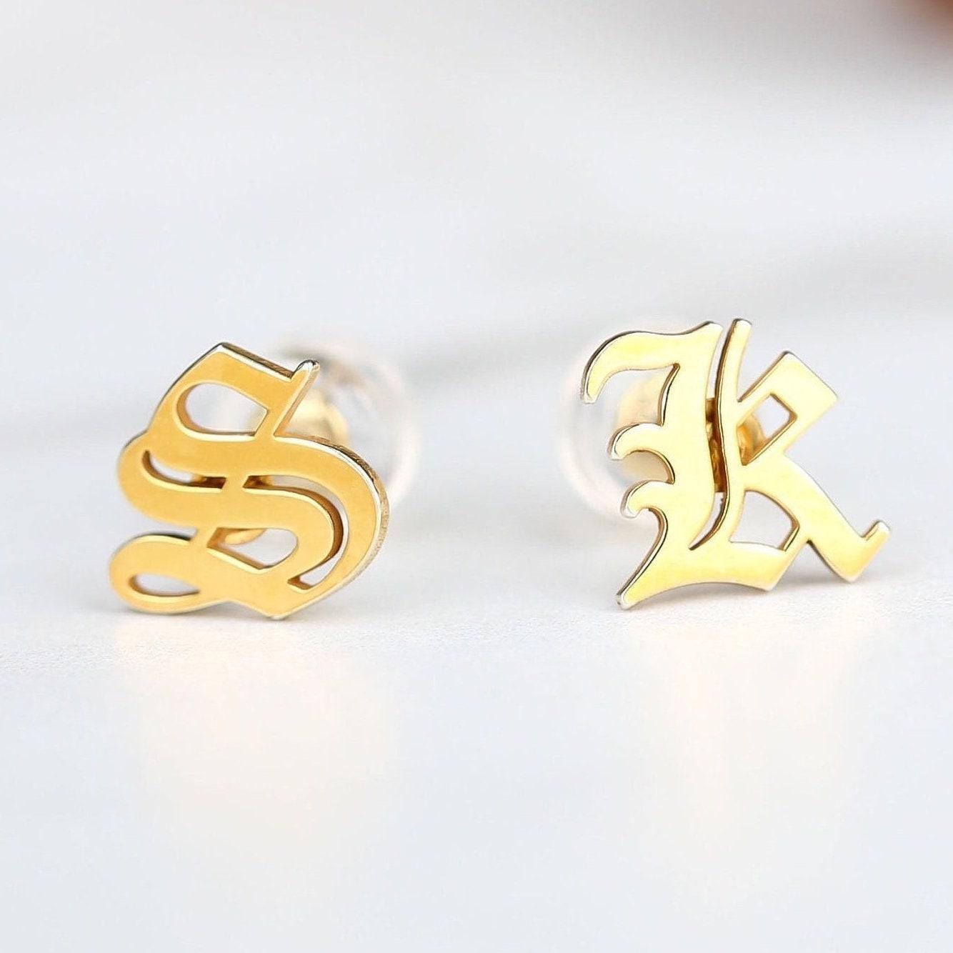 Pair of tiny gold initial letter stud earrings on plain posts (2 of 13)