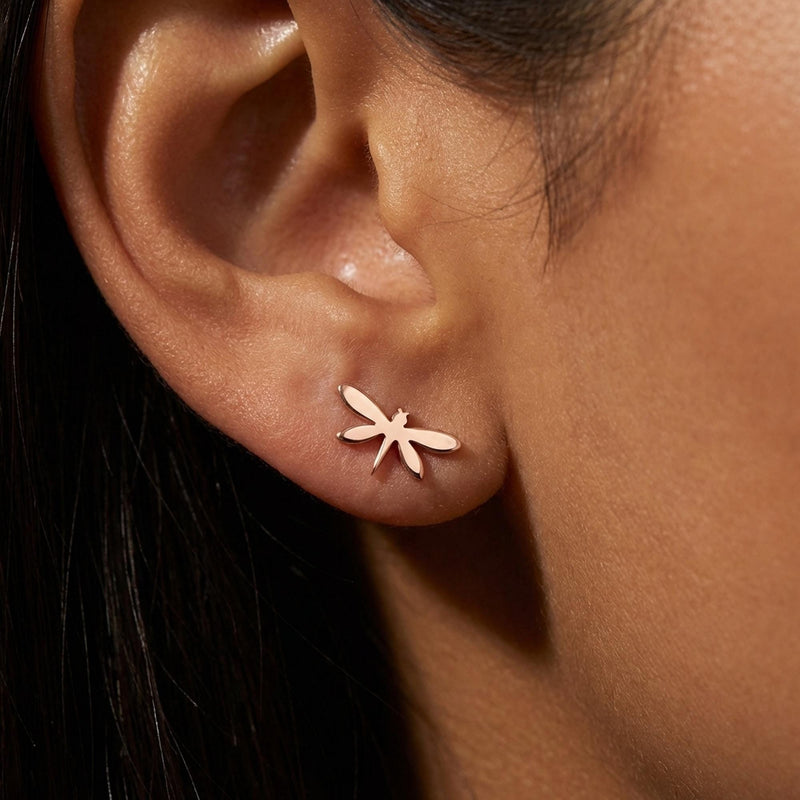 Pair of narrow gold dragonfly stud earrings with four wings, shown front on. (4 of 11)