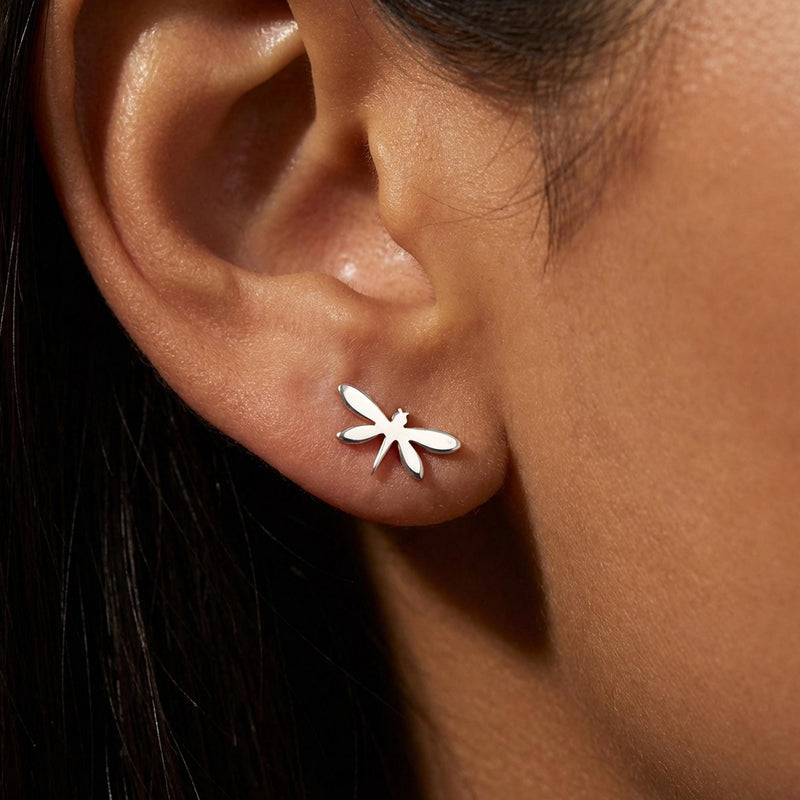 Pair of narrow gold dragonfly stud earrings with four wings, shown front on. (5 of 11)