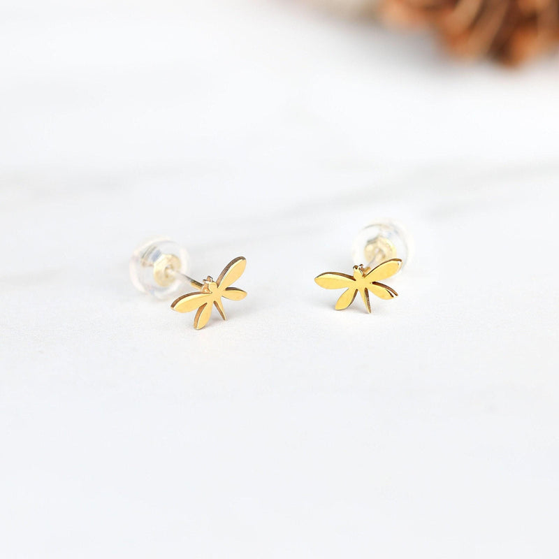 Pair of narrow gold dragonfly stud earrings with four wings, shown front on. (6 of 11)