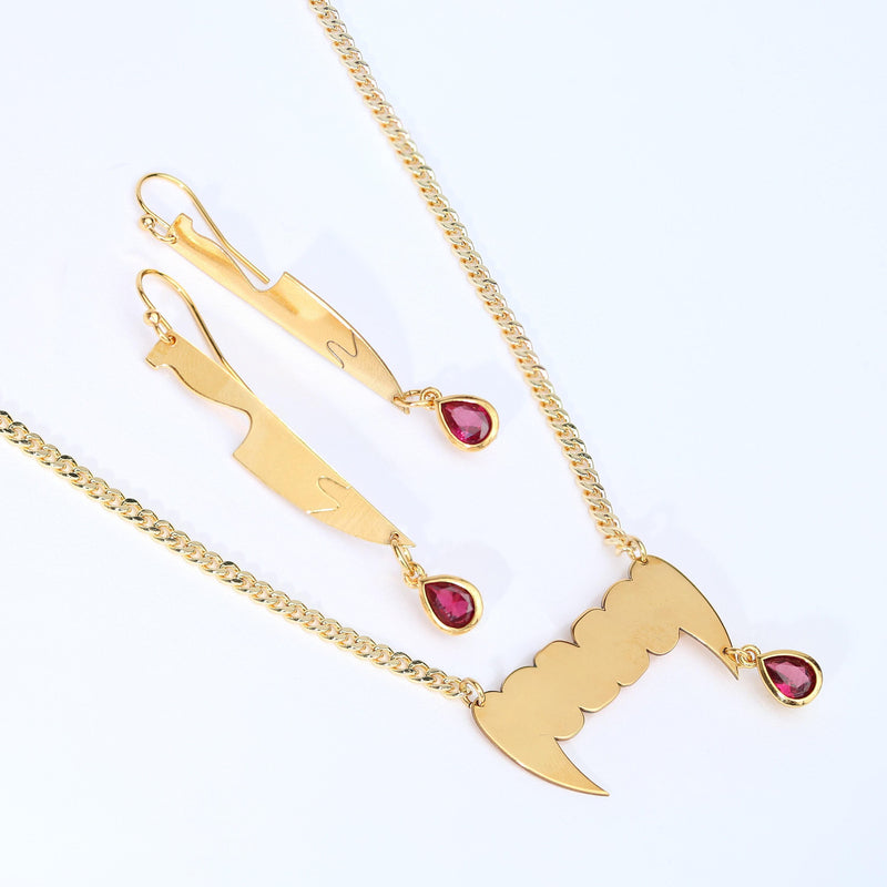 Small silver vampire fang pendant on a fine chain necklace