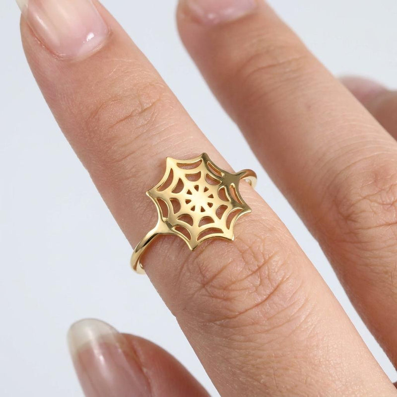Thin gold ring with a delicate spider web pattern traced around the band (2 of 16)