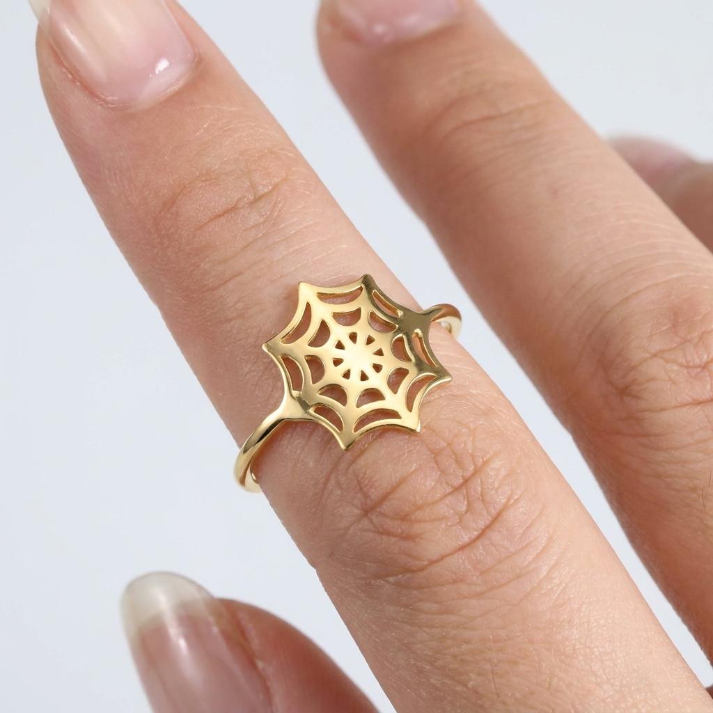 Thin gold ring with a delicate spider web pattern traced around the band (2 of 16)