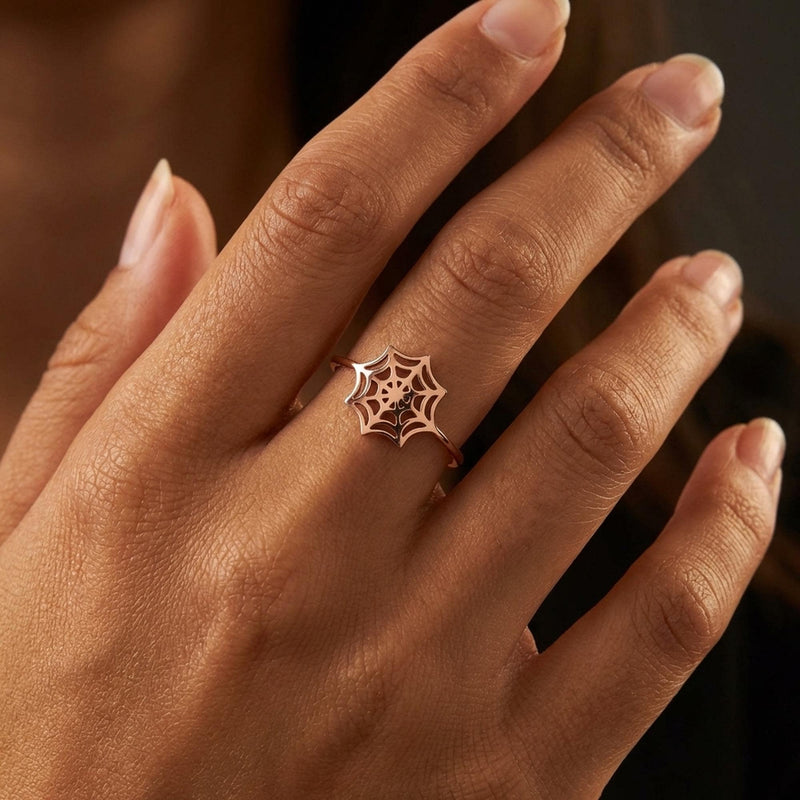 Thin gold ring with a delicate spider web pattern traced around the band (9 of 16)
