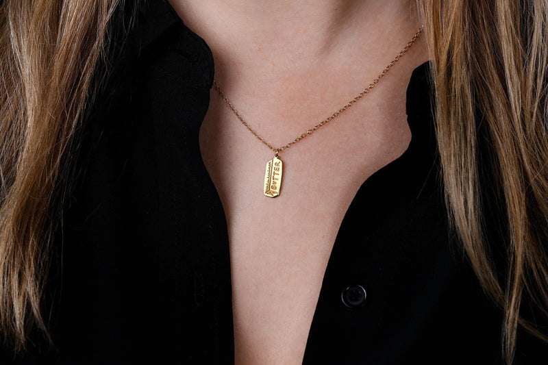Fine gold chain necklace with a small pendant shaped like a stick of butter (7 of 13)