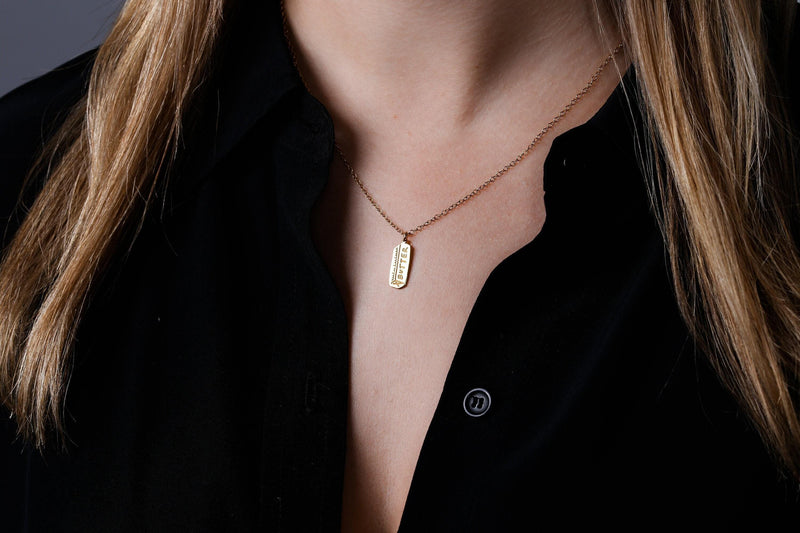Fine gold chain necklace with a small pendant shaped like a stick of butter (8 of 13)