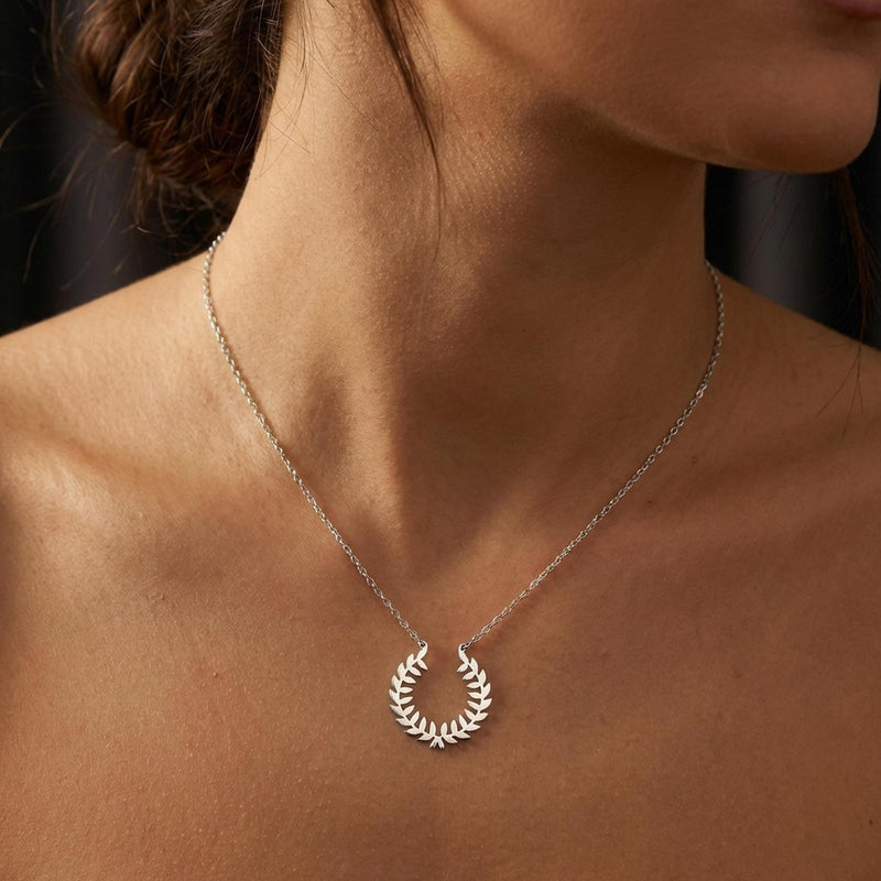 Gold laurel wreath pendant with two leafy branches meeting at the base on a chain (9 of 9)