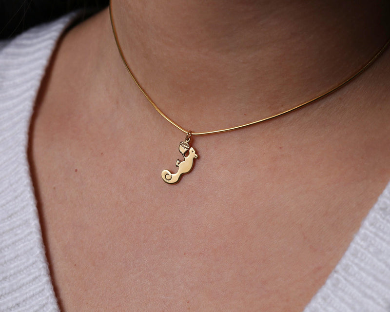 Gold squirrel charm with a small acorn on a fine cable chain necklace
