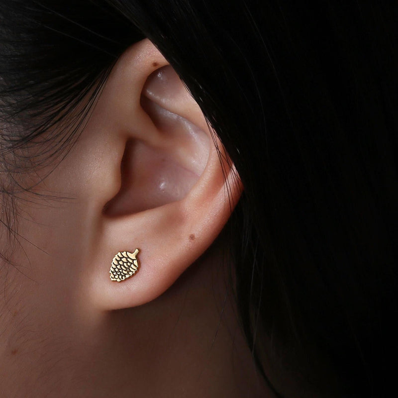 Pair of small textured pinecone stud earrings in gold, shown front-on