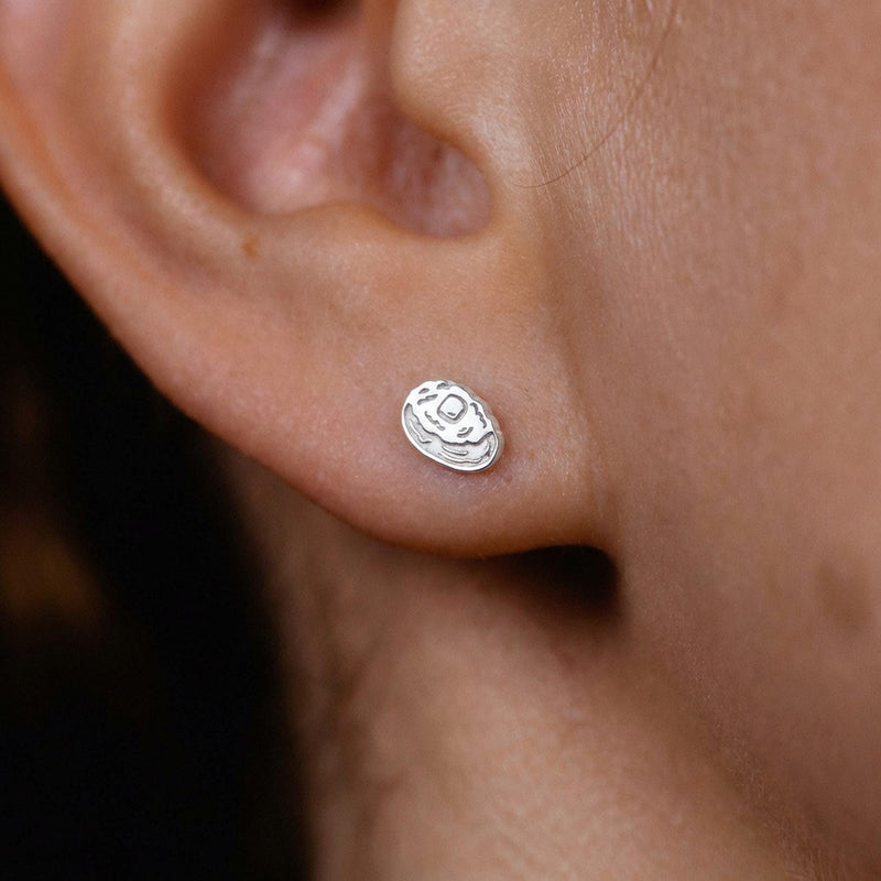 Pair of tiny gold baked potato stud earrings split open with butter on top (7 of 8)