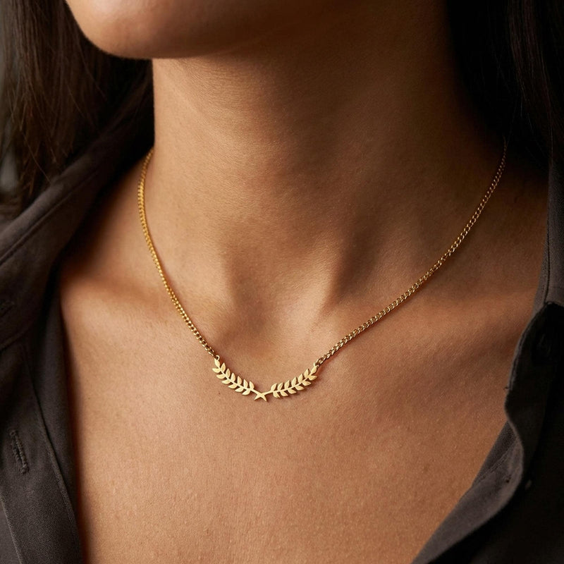 Slim curved gold olive branch pendant with two leaves on a fine chain (11 of 12)