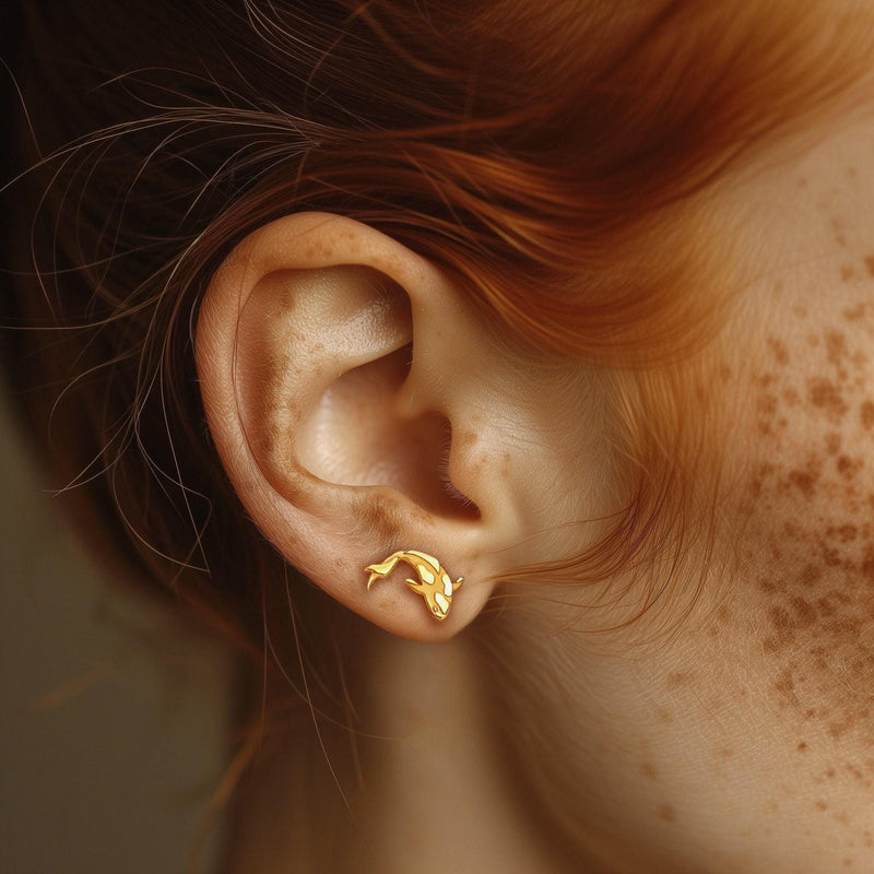 Pair of small gold koi fish stud earrings with fanned fins, white background. (7 of 7)