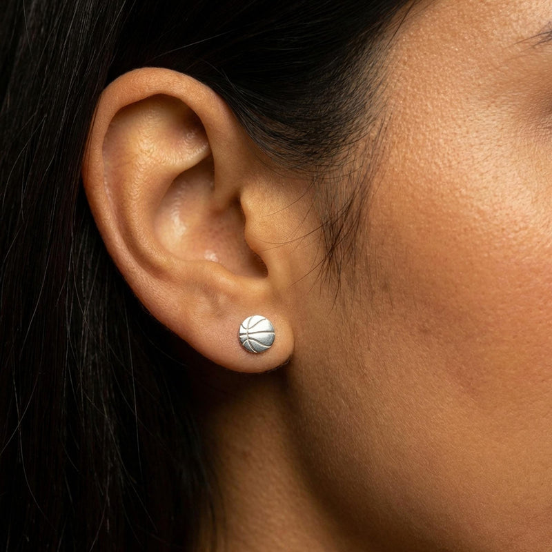 Pair of round gold basketball stud earrings with cut seam lines (11 of 11)
