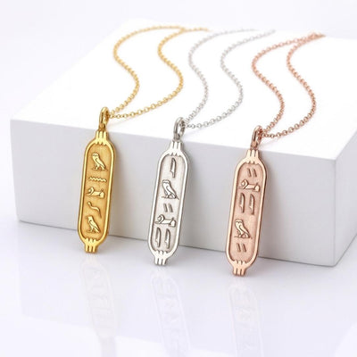 Slim vertical oval cartouche pendant in gold on a fine cable chain